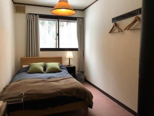 Postel nebo postele na pokoji v ubytování GUEST HOUSE ZU-THONES HAKUBA