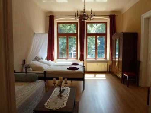 a bedroom with a bed and a large window at Fewo Gründerzeitflair in Görlitz