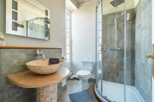 a bathroom with a bowl sink and a shower at 5 Grande Rue in Le Lude