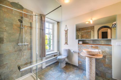 a bathroom with a shower and a sink and a toilet at 5 Grande Rue in Le Lude