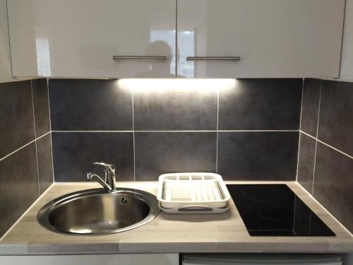 a kitchen counter with a sink and a sink at Studio Prapoutel 3 pers, balcon - FR-1-557-116 in Les Adrets