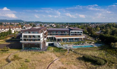 an aerial view of a large building with a swimming pool at Thalazur Cabourg - H&ocirc;tel & Spa in Cabourg