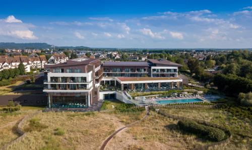 an aerial view of a large building with a swimming pool at Thalazur Cabourg - Hôtel & Spa in Cabourg