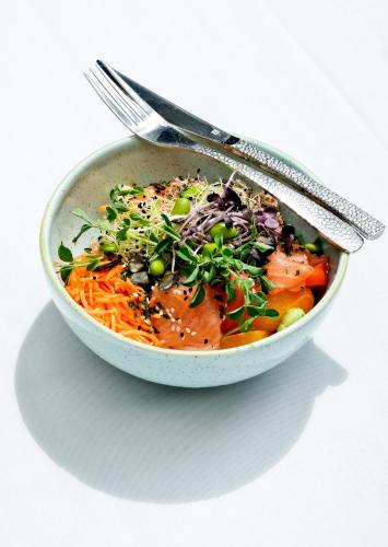 a bowl of food with a spoon and a fork at Thalazur Cabourg - Hôtel & Spa in Cabourg