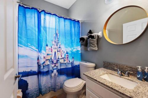 a bathroom with a disney shower curtain and a sink at Spacious Disney Themed 5Bed Villa! Private Heated Enclosed Pool/Spa/BBQ! in Davenport