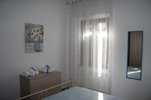 a bedroom with a bed and a mirror and a window at L'Acero di STALL in Viterbo