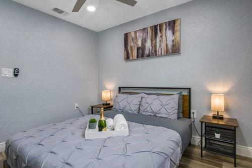 a bedroom with a large bed with two lamps on it at Cozy & Fully Renovated FREE Heated Pool Home! in Largo
