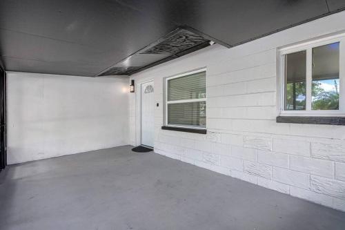 an empty room with white walls and windows at Cozy & Fully Renovated FREE Heated Pool Home! in Largo