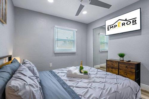 a bedroom with a bed with a wine bottle on it at Cozy & Fully Renovated FREE Heated Pool Home! in Largo