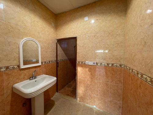 a bathroom with a sink and a shower and a mirror at سجى2 in AlUla