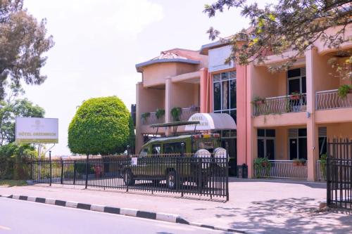 a green bus parked in front of a building at Hotel Greenwich in Kigali