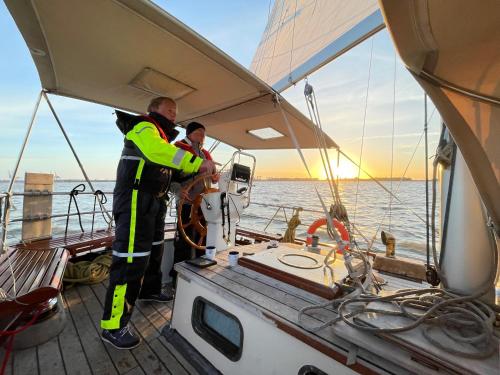 two men standing on a boat in the water at Classic sailing ship in center of Enkhuizen! in Enkhuizen