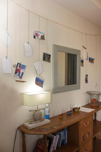 a room with a table with a mirror on a wall at Orfea's Place in Riglia
