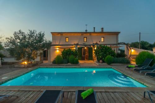 a house with a swimming pool in front of a house at Son Indiot in Algaida