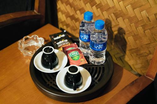 a table with two plates and two bottles of water at Pao's Leisure Homestay in Ha Giang