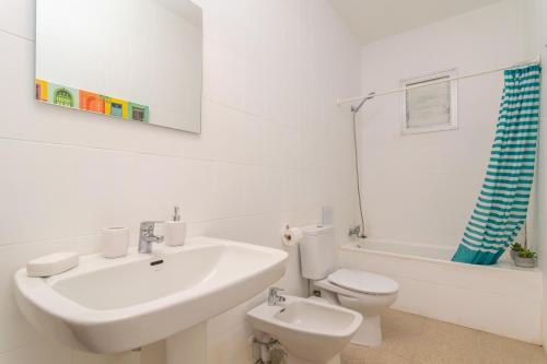 a white bathroom with a sink and a toilet at Son Indiot in Algaida