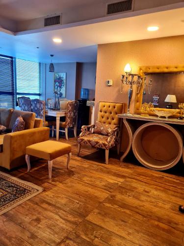 a living room with a couch and a table at Royal Residencia Centaurus in Islamabad