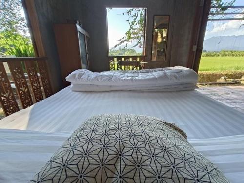 two large white beds sitting on a porch at 467 Chiang Dao in Chiang Dao