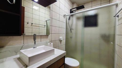 a bathroom with a sink and a shower and a toilet at Mirante das Aguas de Piratuba in Piratuba
