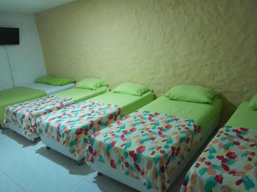 a room with three beds in a room at CASA FLOR DE LIZ in Villavieja
