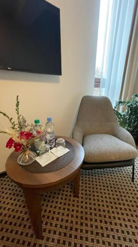 a living room with a coffee table and a chair at Hotel Silvia Gold Gliwice in Gliwice