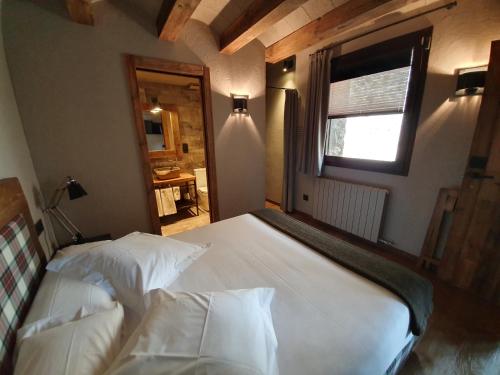 a bedroom with two white beds and a window at Hotel Boutique Puig Francó - Adults Only in Camprodon