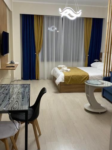 a bedroom with a bed and a table and a chair at Tsaghkadzor,Alvina Complex Apartament 175 in Tsaghkadzor