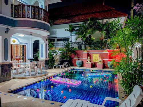 a swimming pool in the middle of a house at MADEE VILLA - PATTAYA HOLIDAY HOUSE WALKING STREET 6 bedrooms in Pattaya South