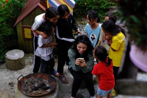 a group of people standing around a fire at La Beauté Sa Pa in Sa Pa