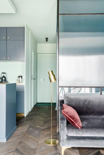 a living room with a couch and a table at Luxueuze suite met frontaal zeezicht in Knokke-Heist