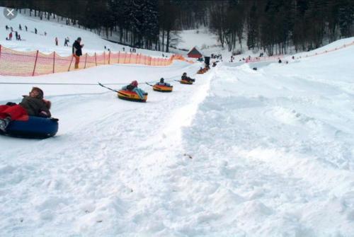 a group of people riding down a snow covered slope at Traumharz in Sankt Andreasberg
