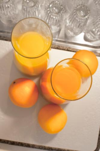 a pile of oranges and a glass of orange juice at Hotel Goldenes Lamm in Idstein