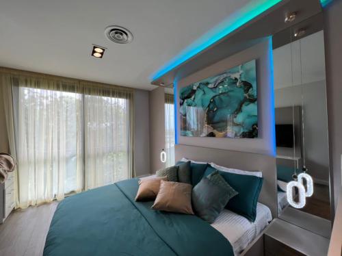 a bedroom with a large bed with blue lights on it at WOW Property Accra the pearl in city in Accra