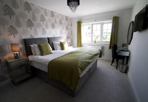 a bedroom with a large bed and a window at The Binsted Inn in Alton
