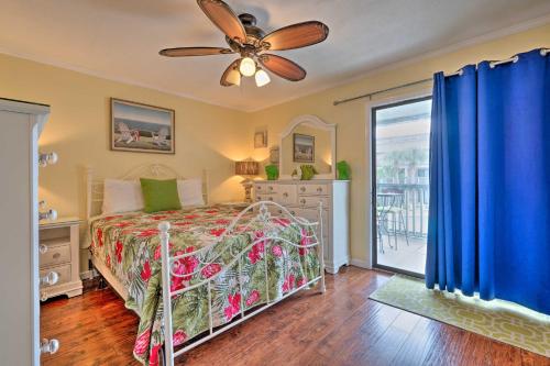 a bedroom with a bed and a ceiling fan at Convenient PCB Condo with Pool Access Walk to Beach in Panama City Beach