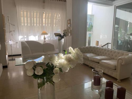 a living room with a couch and a vase of flowers at Eveline Portosole Hotel in Sanremo