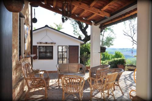 a group of chairs and a table on a patio at Casa Civetta in Castel Colonna