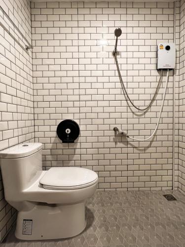 a white bathroom with a toilet and a shower at KohLan Hansa in Ko Larn