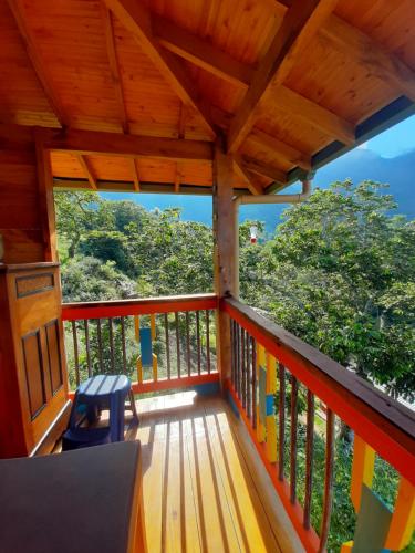 a balcony of a house with a wooden roof at Jaibaná Spa in Támesis