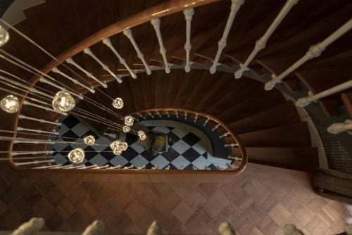 a spiral staircase in a house with a checkered floor at Villa Weber - self check-in in Aarburg