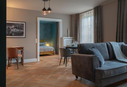 a living room with a couch and a dining room at Villa Weber - self check-in in Aarburg