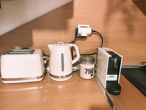 a counter with a coffee maker and a toaster and a cell phone at Casa Encanto in Lajares