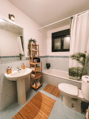 a bathroom with a sink and a tub and a toilet at Casa Encanto in Lajares