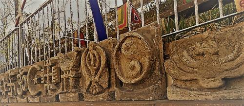 a stone wall with a fence next to at Casa Civetta in Castel Colonna
