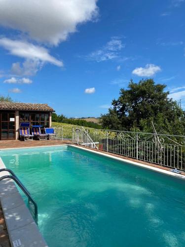 a large pool with blue water in a yard at Casa Civetta in Castel Colonna