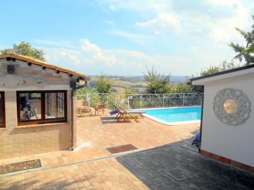 a house with a patio and a swimming pool at Casa Civetta in Castel Colonna