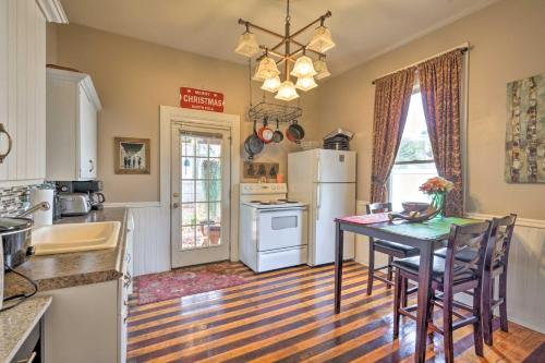 a kitchen with a table and a refrigerator at Spacious Victorian Home quarter Mi to Holiday Valley! in Ellicottville