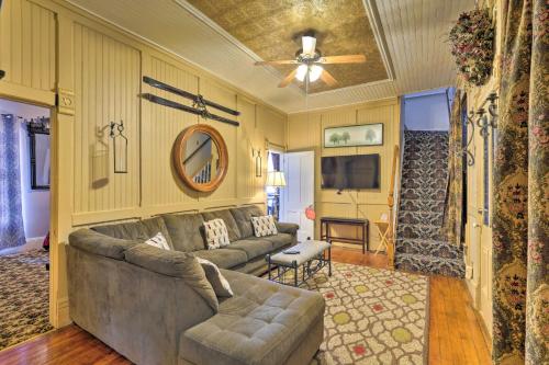 a living room with a couch and a ceiling fan at Spacious Victorian Home quarter Mi to Holiday Valley! in Ellicottville