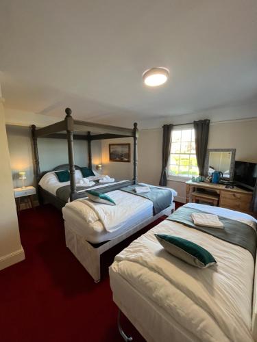 a hotel room with two beds in a room at Castle Inn in Hythe