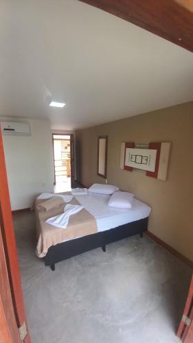 a bedroom with two beds in a room at Pousada Cordel de Itaúnas in Itaúnas
